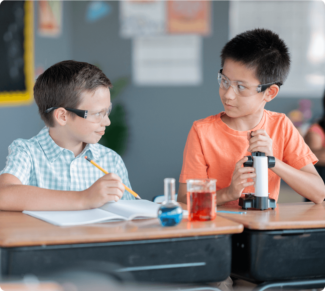 Children wearing goggles, studying chemistry