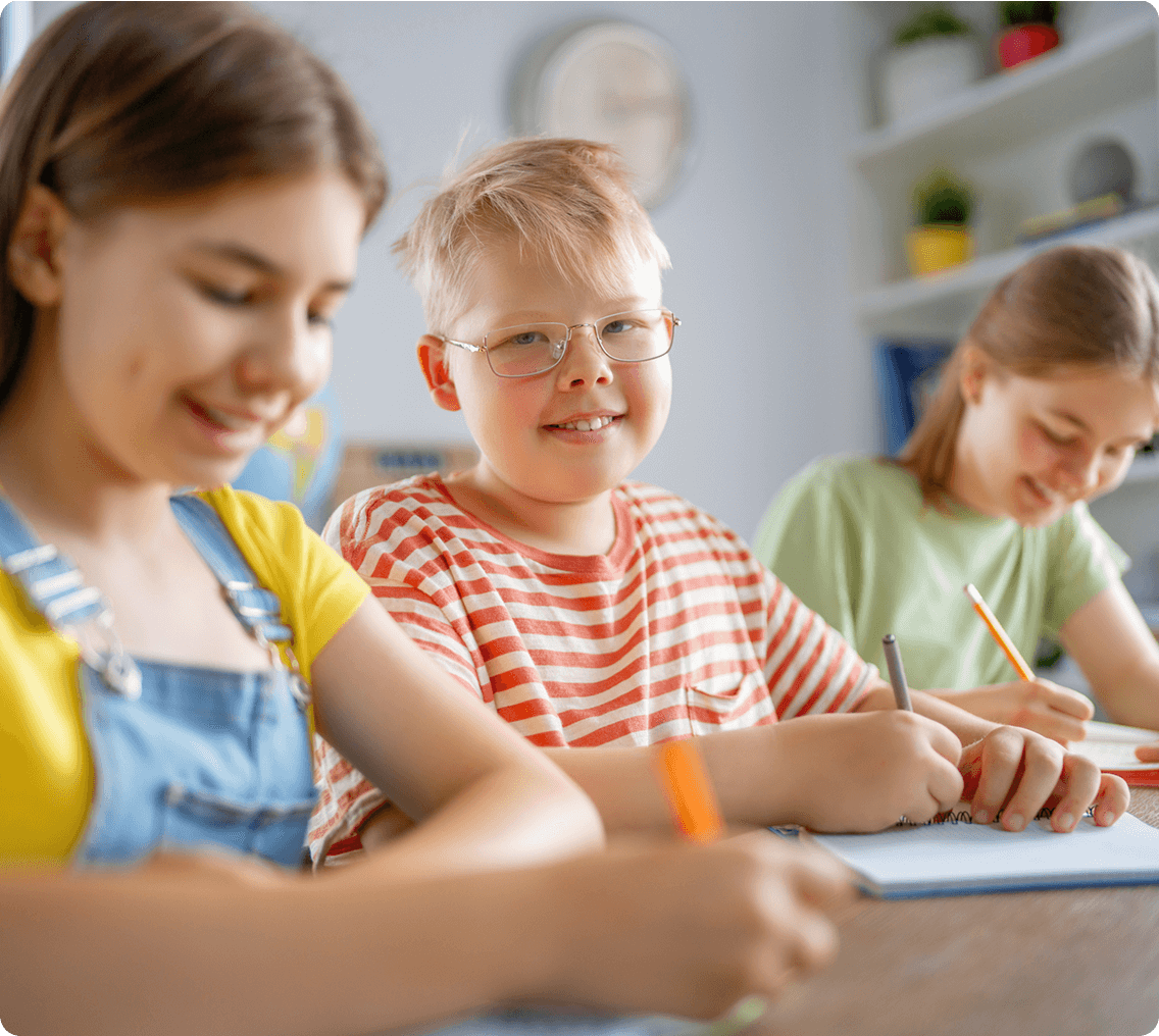 Smiling children doing homework together