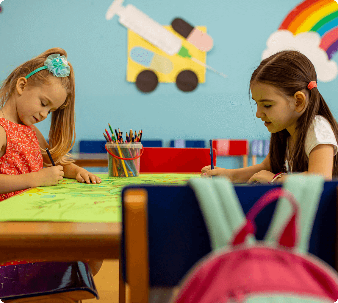 Children drawing in a colorful classroom