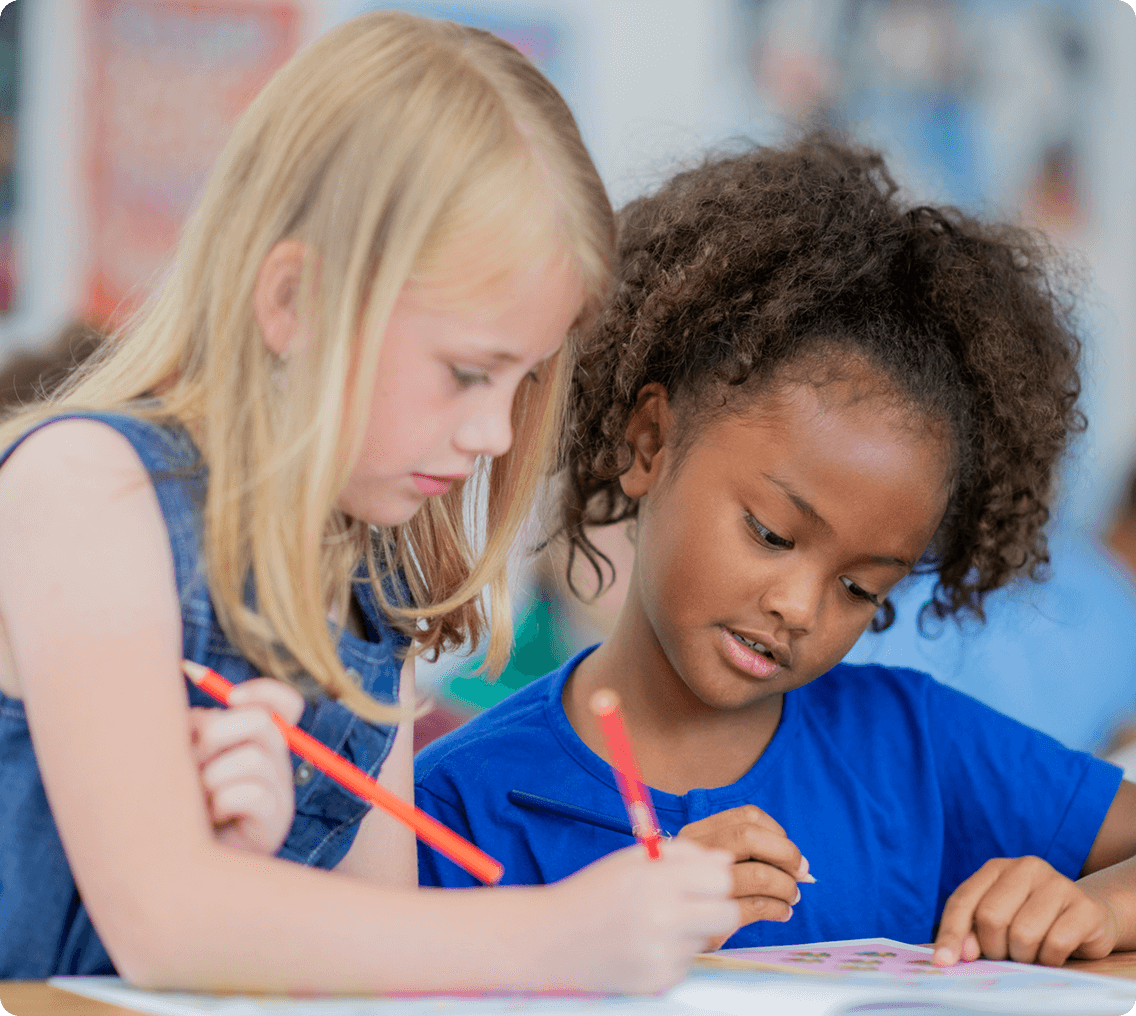 Children drawing together in classroom