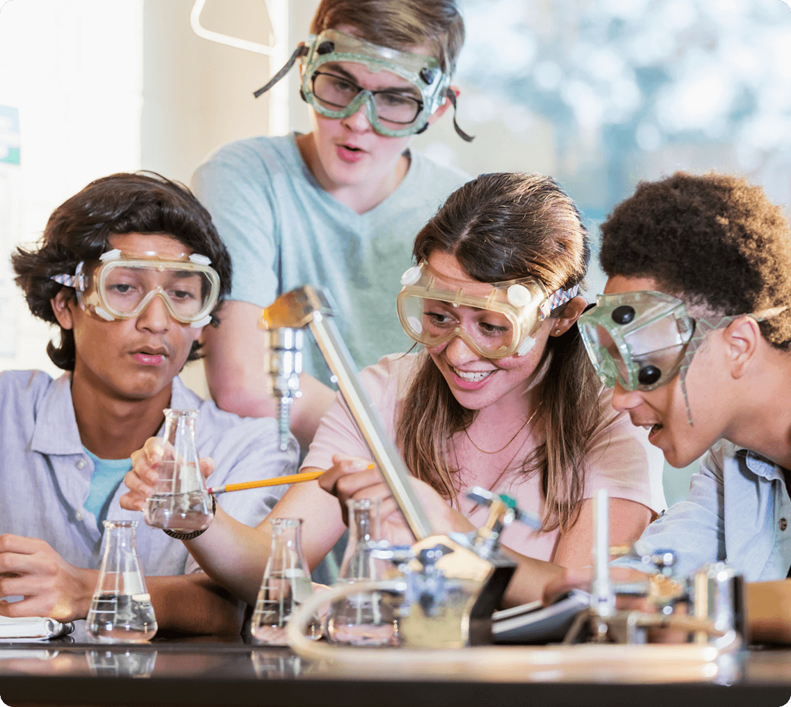 Young scientists wearing safety goggles