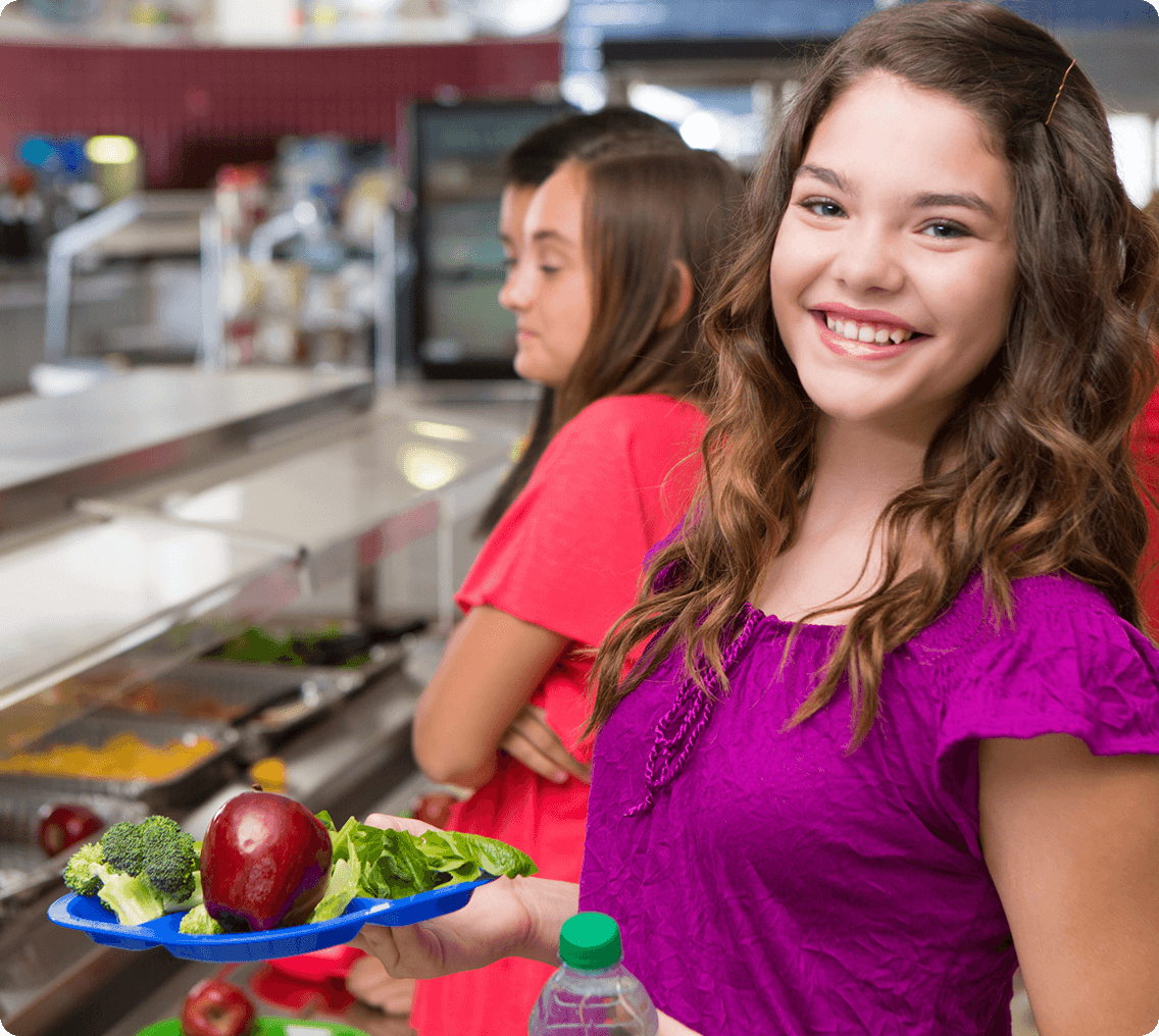 Girl smiling with healthy lunch plate