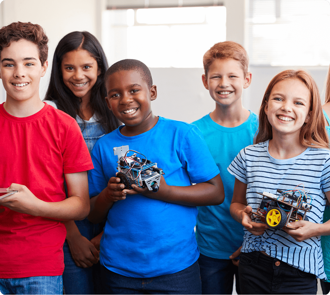 Smiling students displaying projects