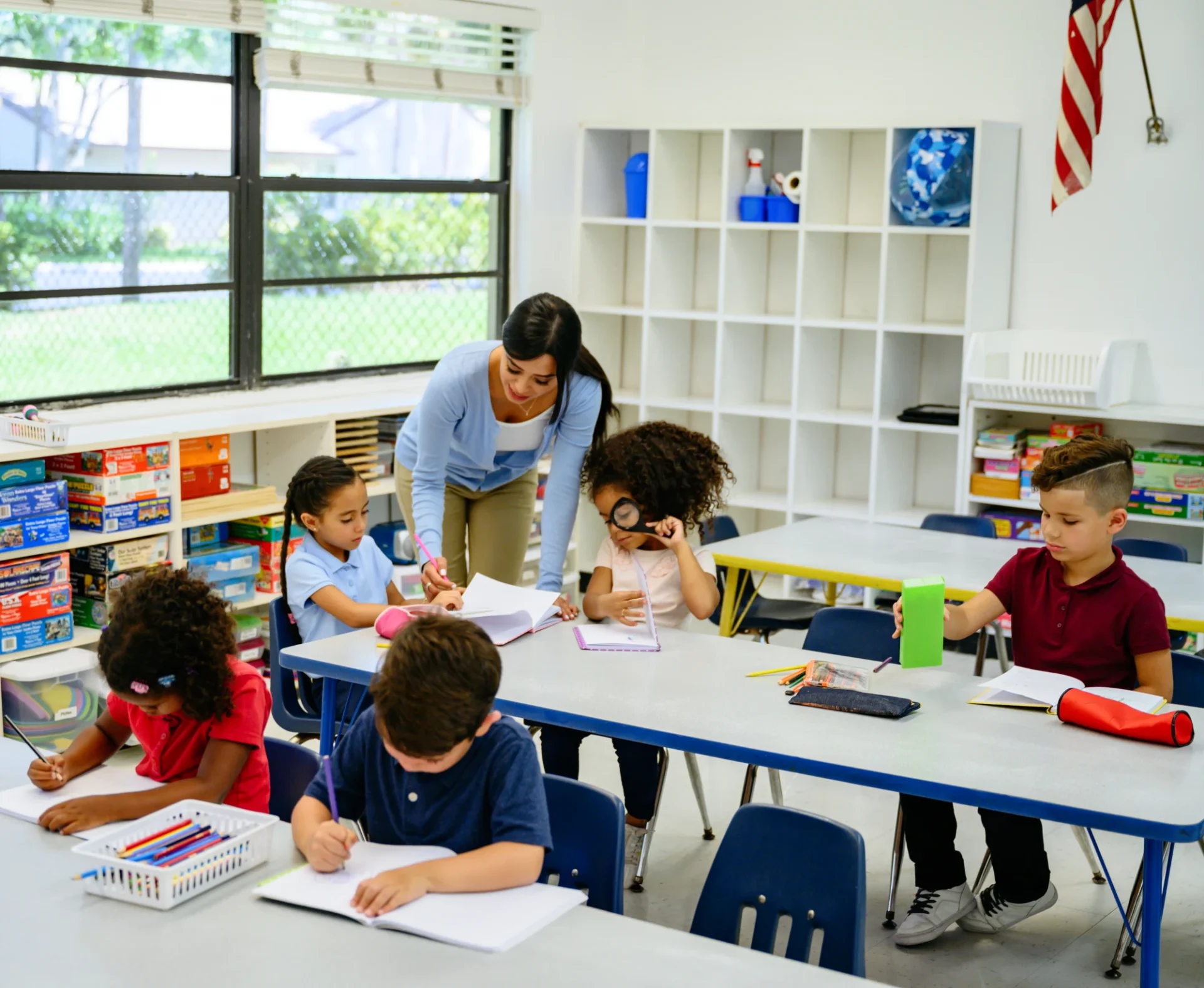 Students working with teacher in classroom