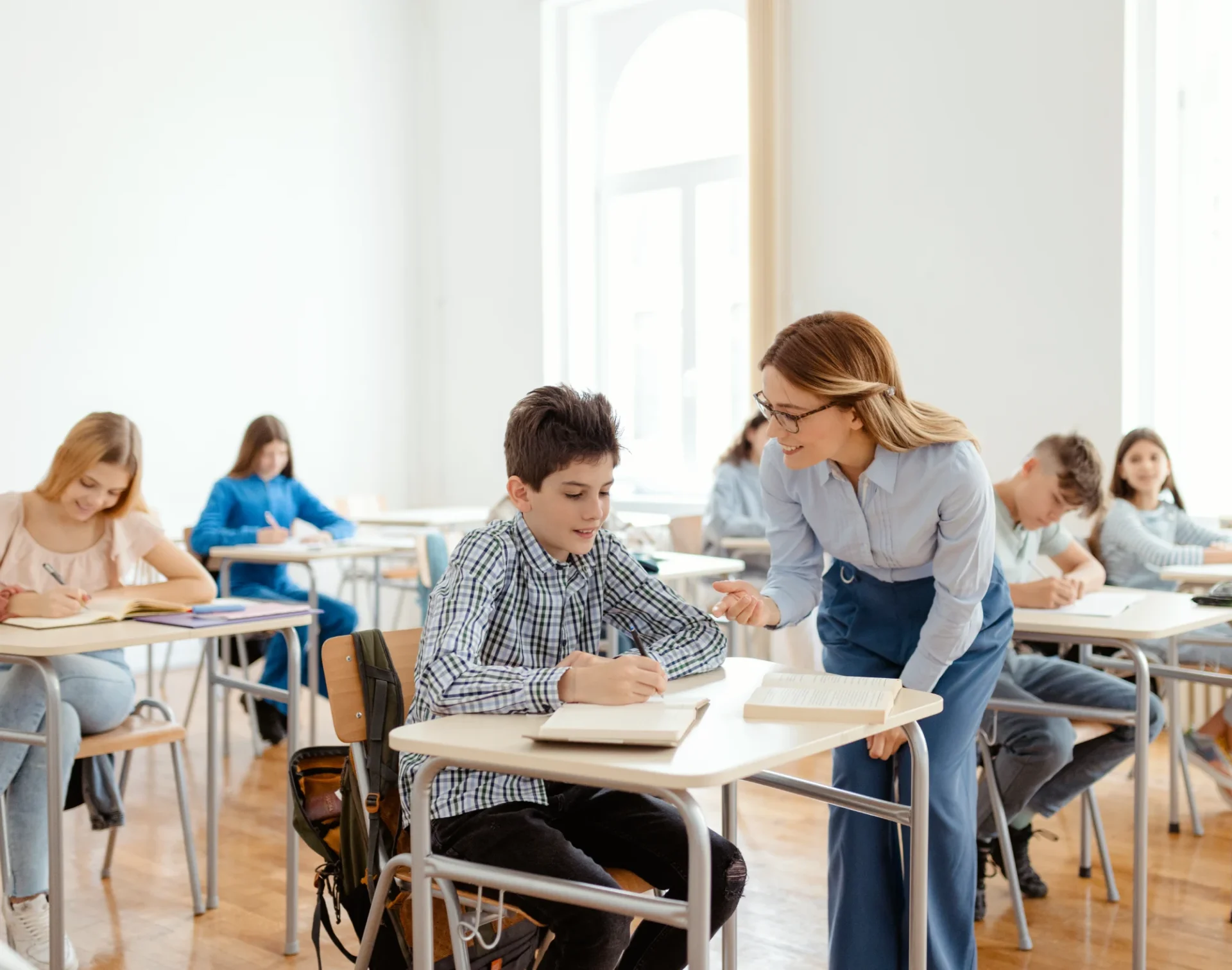Teacher assisting student in classroom