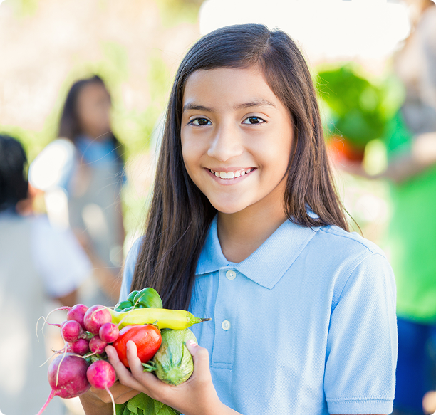 Smiling girl with garden produce