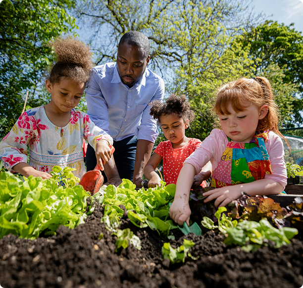 Children gardening with adult supervision