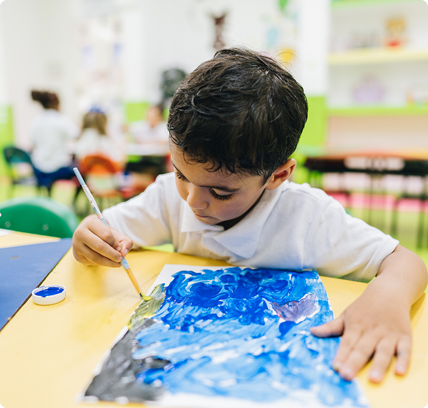 Young boy focused on art project