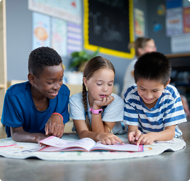 Children reading together on classroom floor