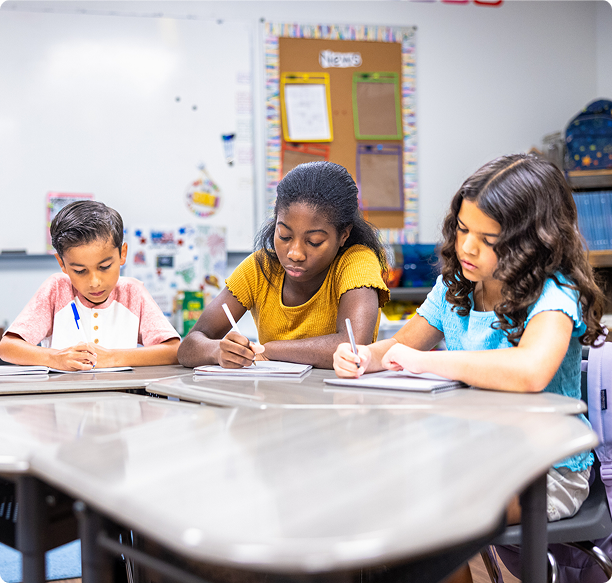 Children focused on classroom writing