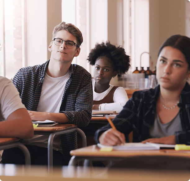 Diverse students taking notes in class