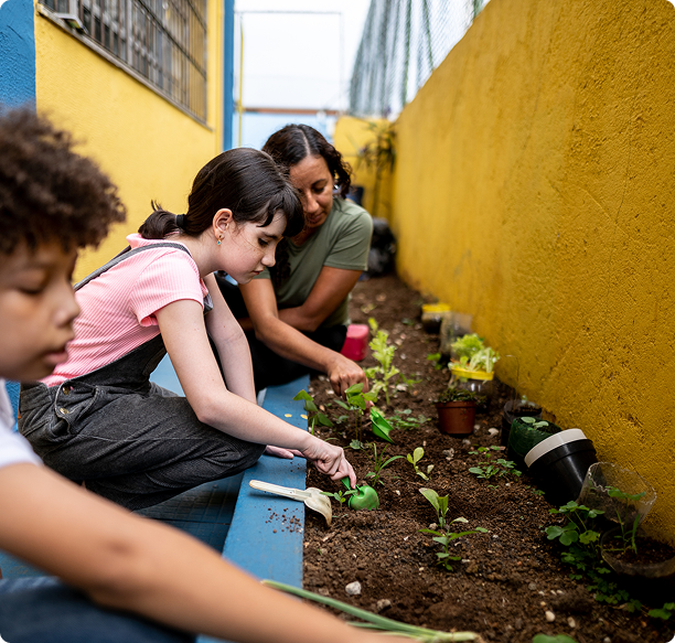 Group gardening near yellow wall