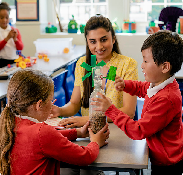 Children learning with teacher in classroom