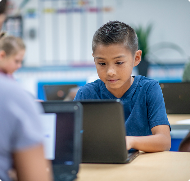 Child learning on laptop in class