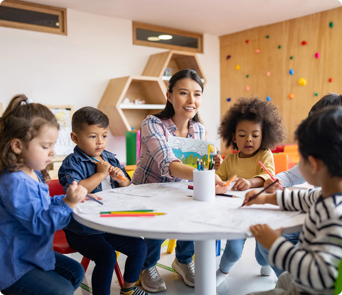Kids coloring with teacher supervision
