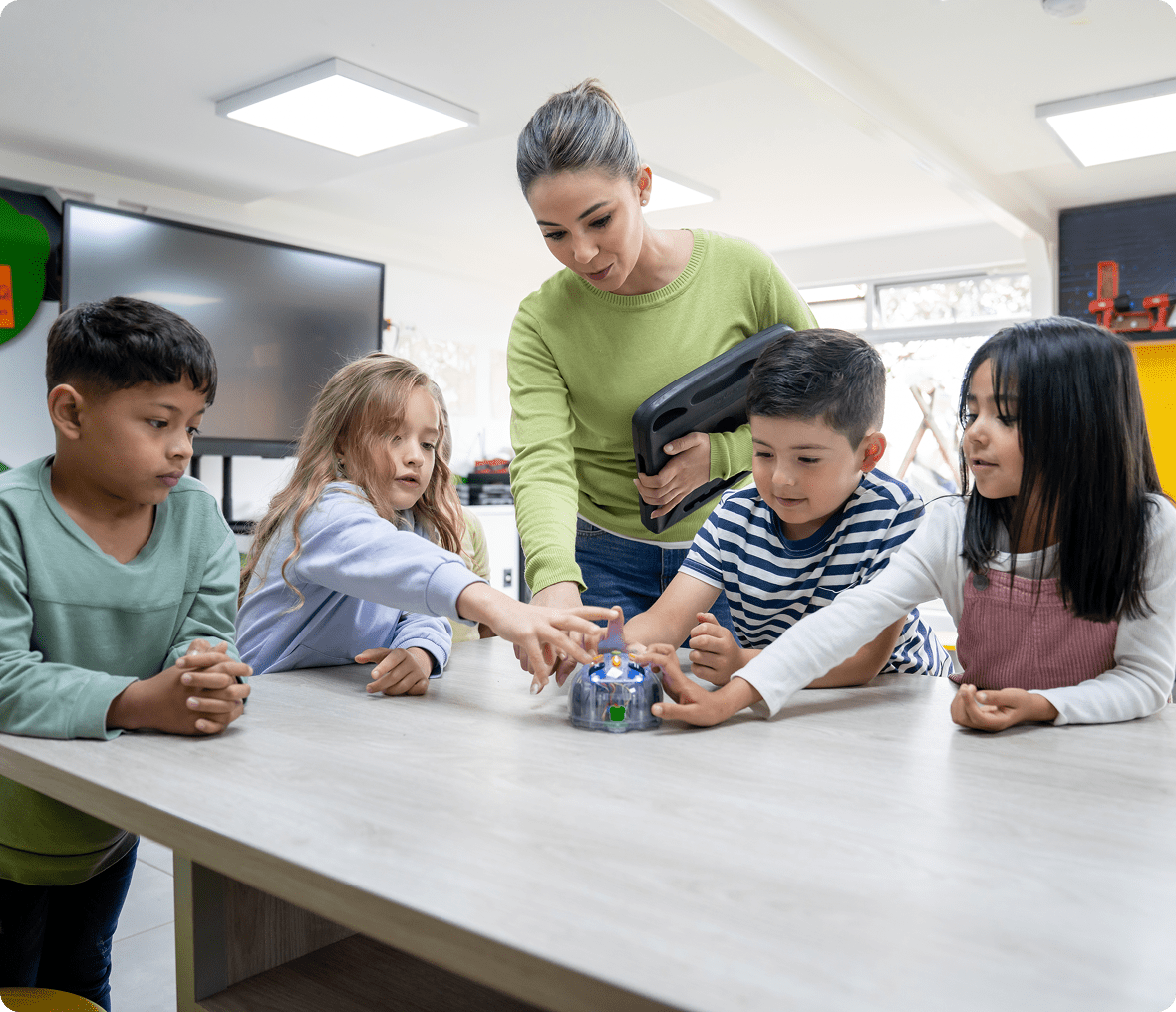 Teacher and students interacting with robot
