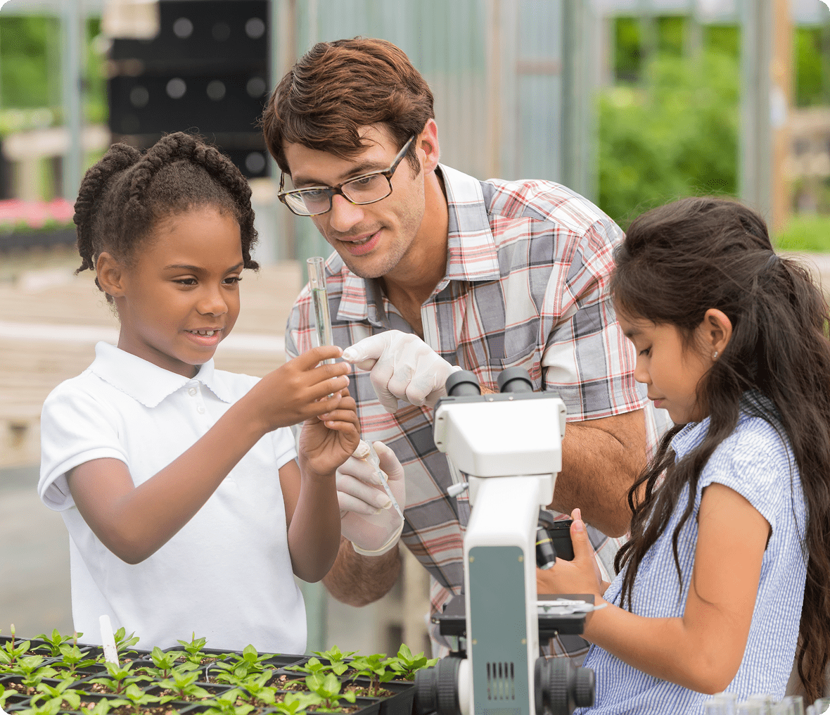 Teacher and children exploring plants
