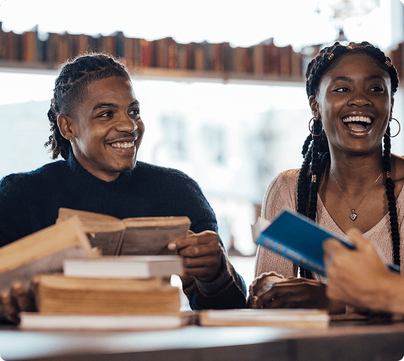 People smiling and reading books together
