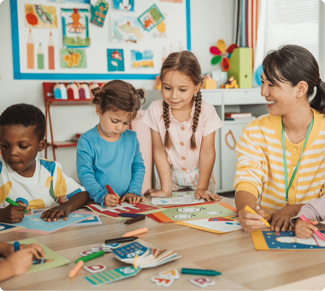 Kids coloring with teacher guidance